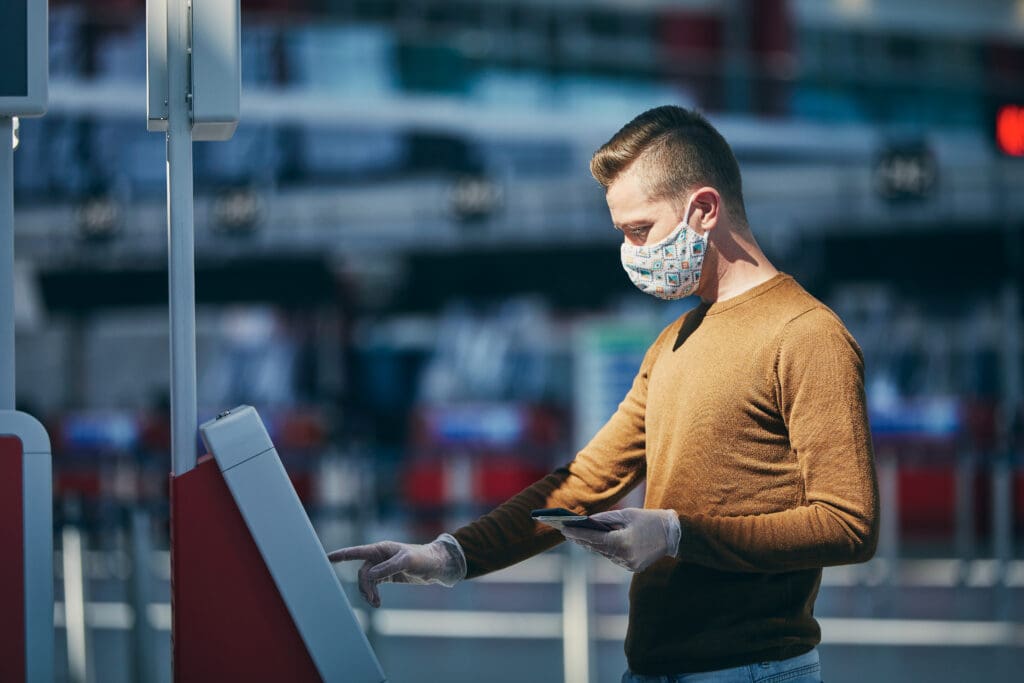 Man,Wearing,Face,Mask,And,Using,Check,In,Machine,At