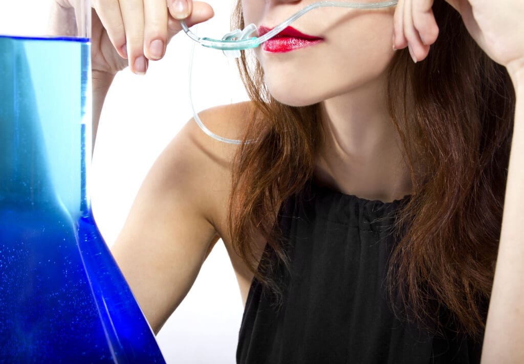 Woman,Inhaling,Flavored,Oxygen,With,Cannula,And,Scented,Water