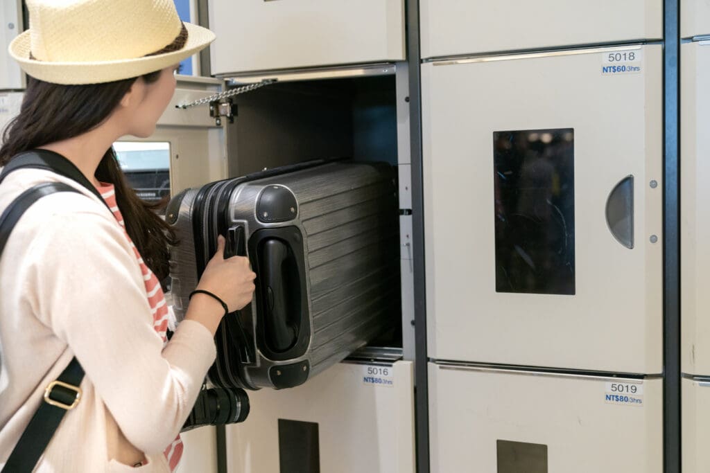 Pretty,Young,Woman,Putting,The,Luggage,In,The,Locker.,Half-body