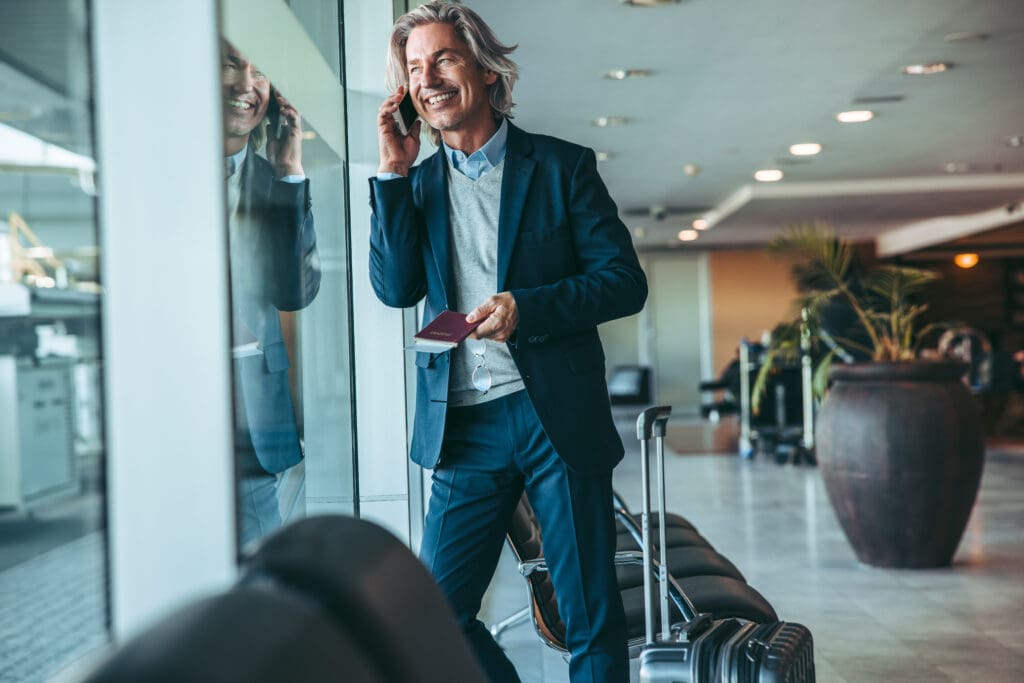 Businessman,At,Airport,Waiting,Lounge,And,Talking,On,Cellphone.,Male