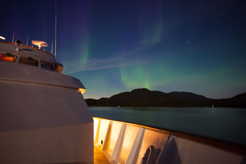 Northern,Lights,Over,A,White,Cruise,Ship,In,Alaska,Reflecting