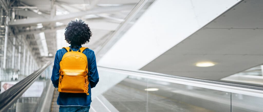 Woman Standing At Airport Terminal