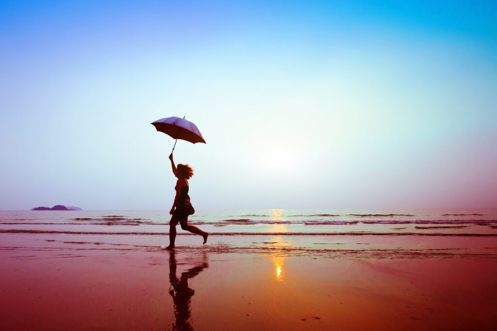 Silhouette,Of,Happy,Running,Woman,With,Umbrella