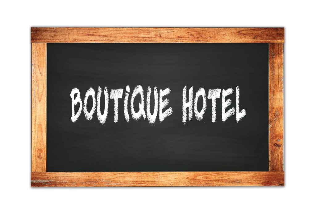 BOUTIQUE  HOTEL text written on wooden frame school blackboard.